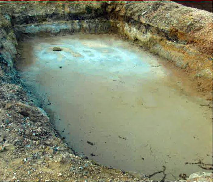 Open pit with oil sheen - component of an oilfiled waste injection well next to Baucum property and home, Laurel, Mississippi